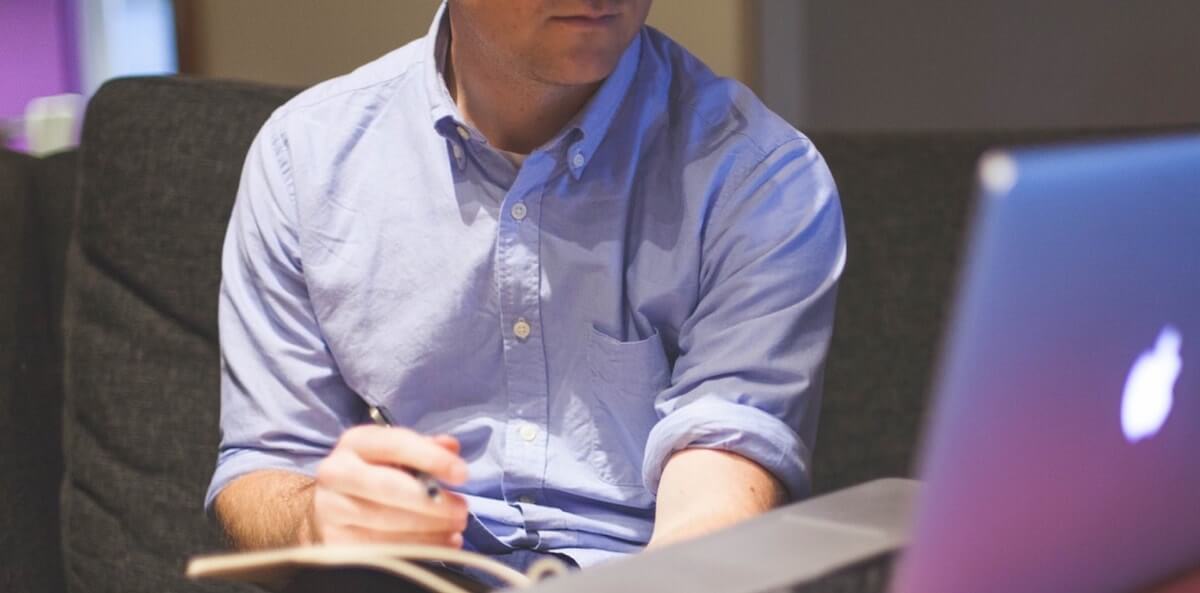 Man looking at computer macbook