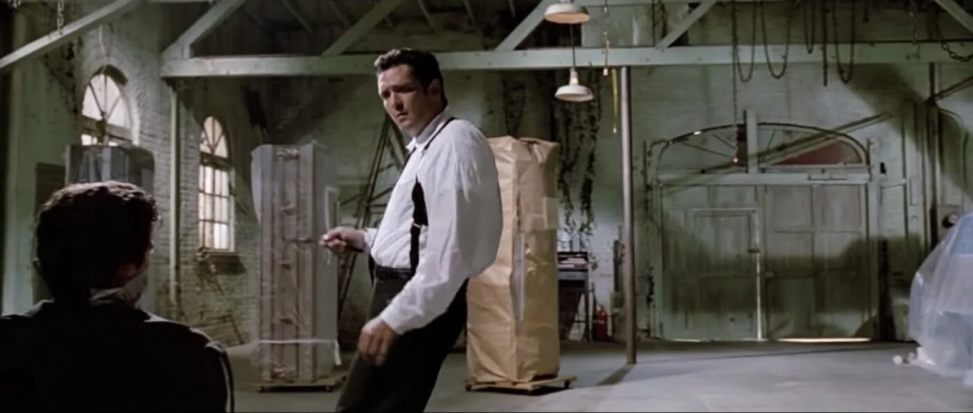 Ultimate Guide To Camera Shots - Michael Madsen Framed In A Hip Level Over The Shoulder Shot For Reservoir Dogs