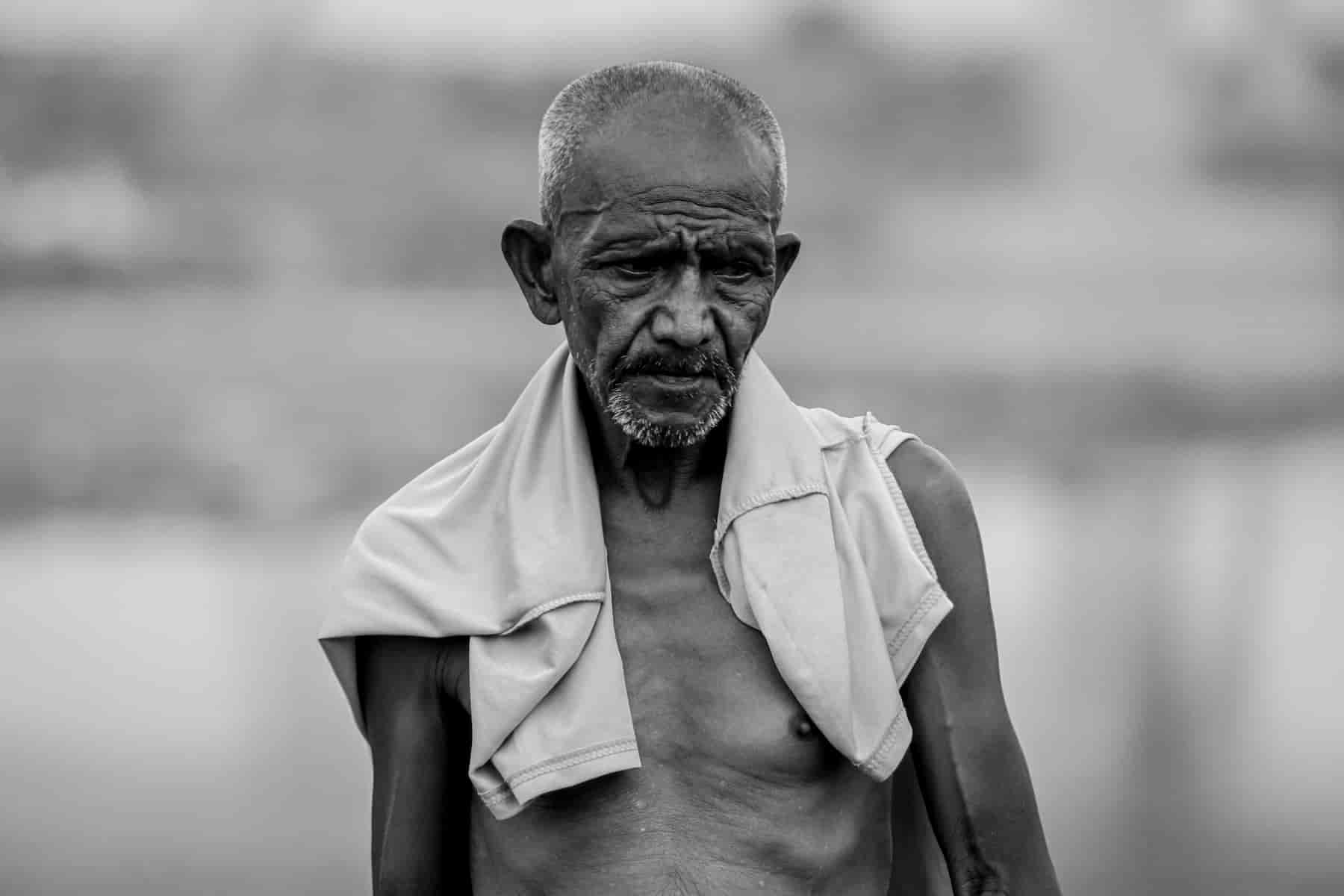 Emotion in street photography ideas Man walking on street by himself without shirt