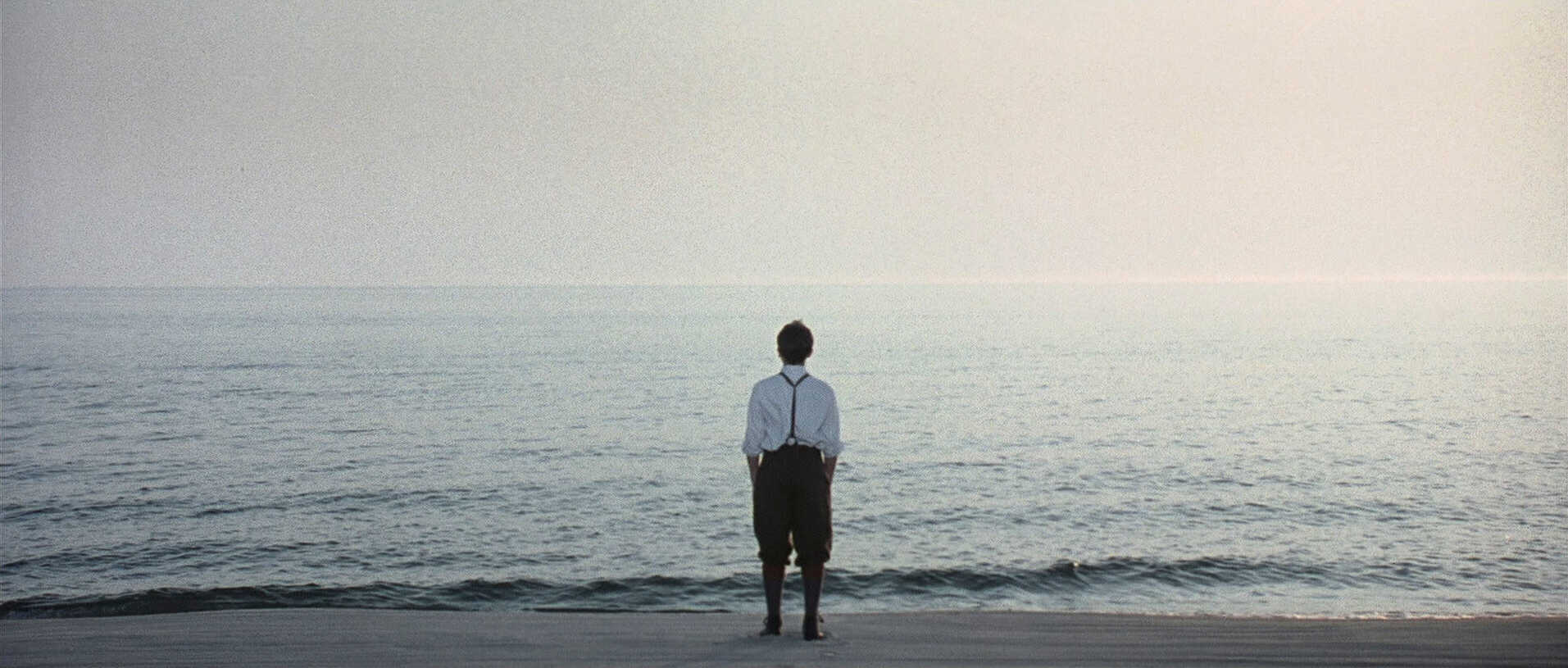 Extreme Wide Shot Example EWS of Tyler Hoechlin standing on sea shore from Road to Perdition